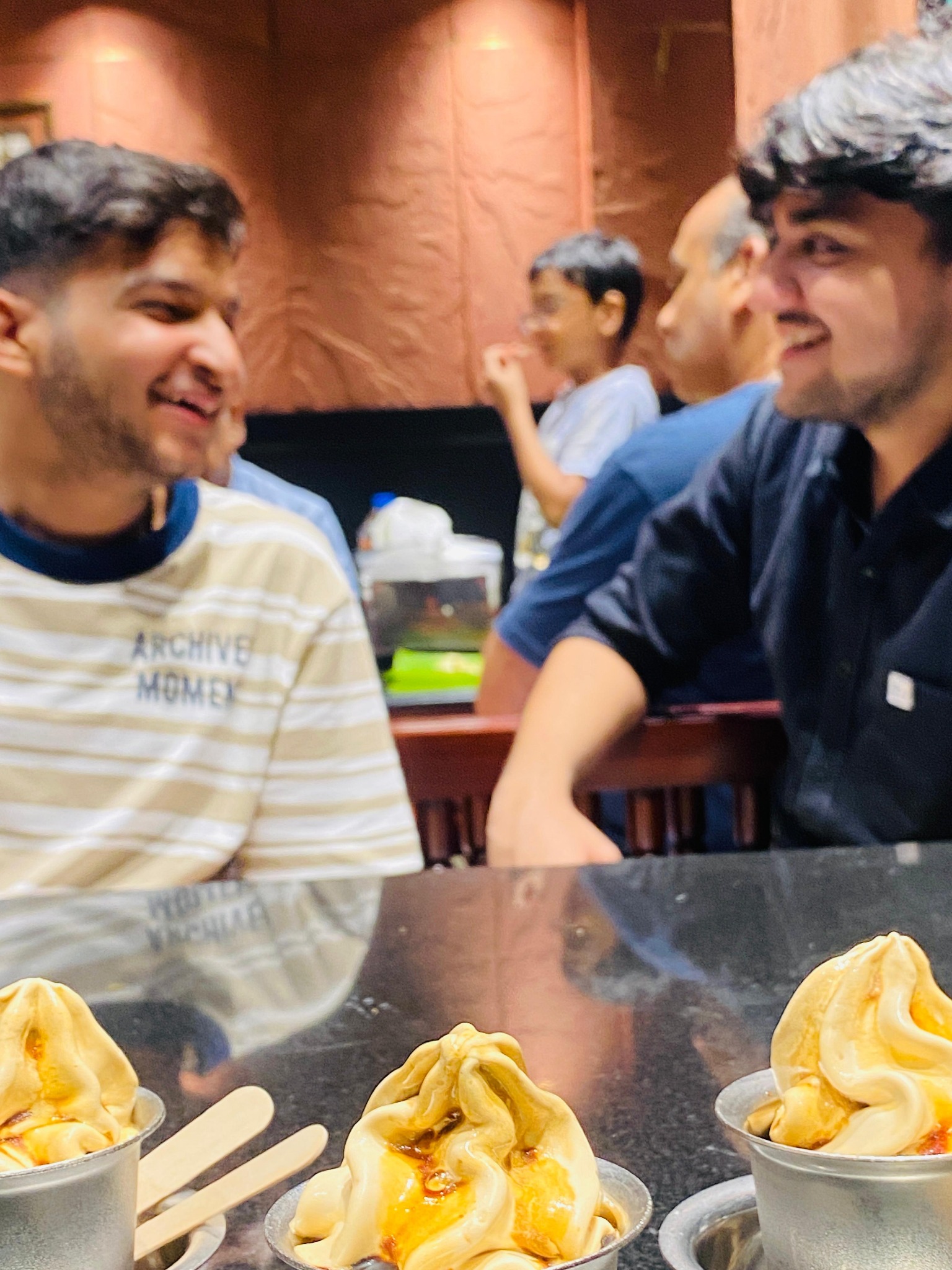 Two friends laughing together at a restaurant