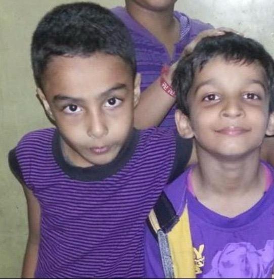 Childhood group photo with two children in purple at the front