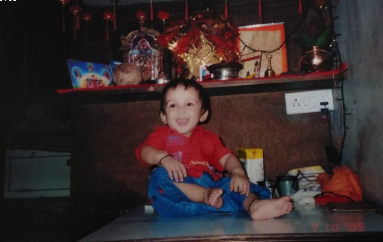 An early childhood photo in a red shirt