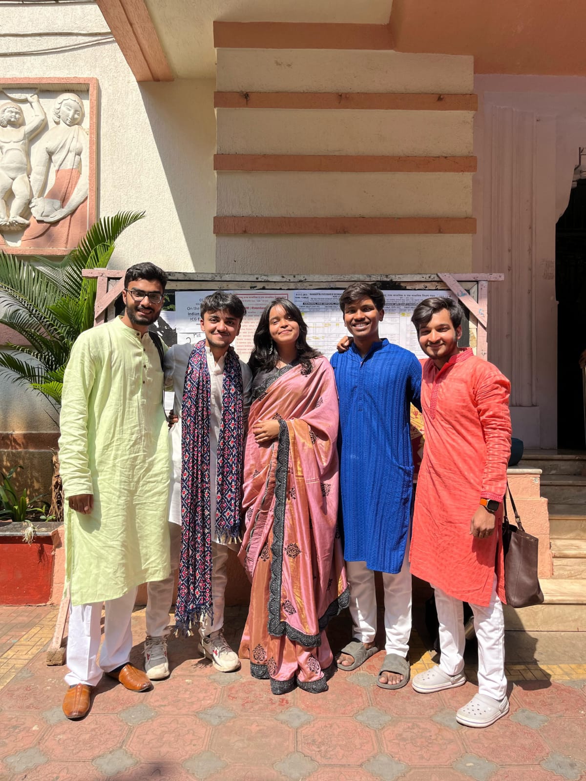 A group photo outdoors in colourful traditional clothes